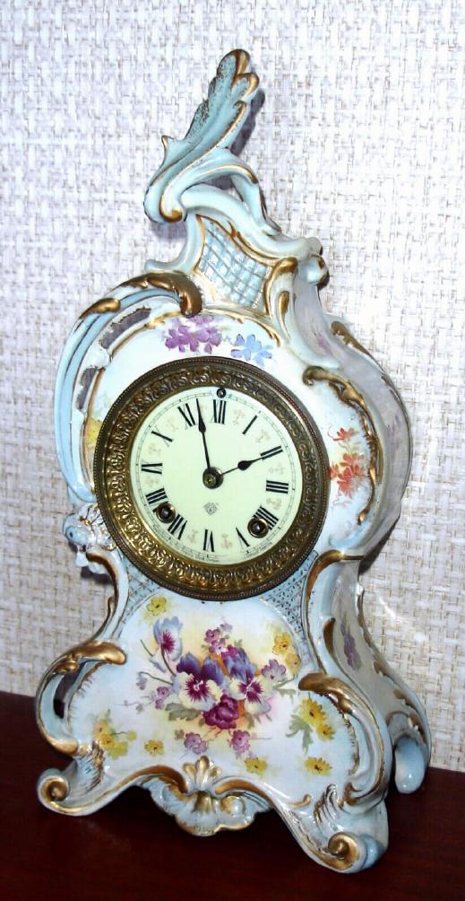 Ansonia Clock Co., C.1895, Royal Bonn, "LA CAPELLE" porcelain china cased clock, with 8-day, gong strike mov't, as-found. Colors are light blue accents on white, with violet and grey pansies. — Antique Clocks Price Guide