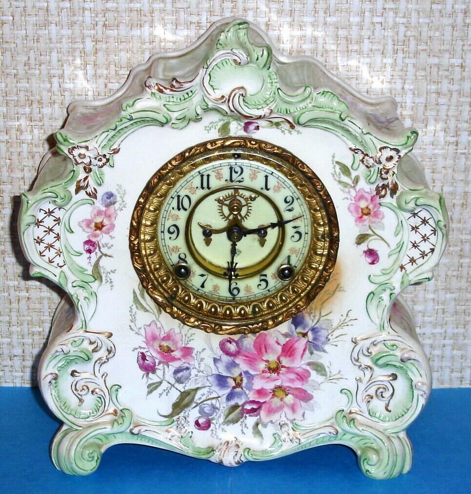 Ansonia Clock Co., Royal Bonn, "LA VOGUE", porcelain clock in the French style, with open escapement on porcelain dial, the creamy case with very light green accents and gold highlights and multi color floral paintings, c1900 — Antique Clocks Price Guide