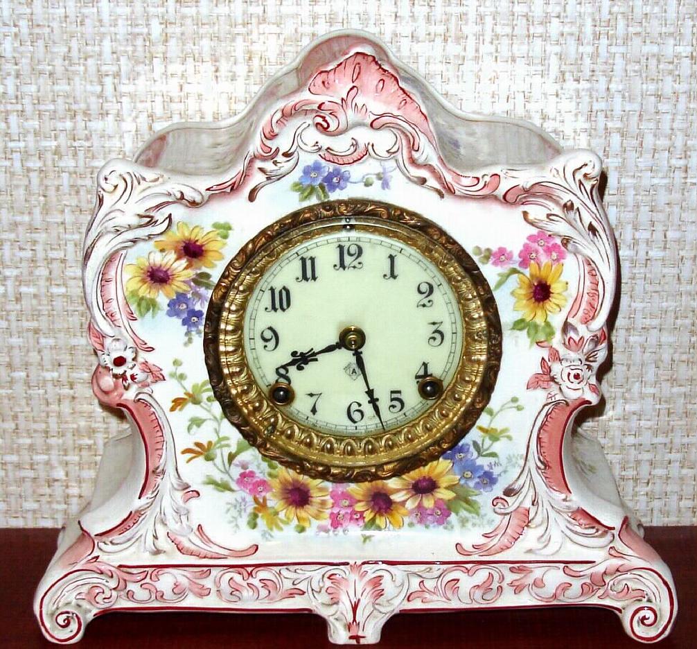 Ansonia Clock Co., C.1905, Royal Bonn, "LA LORNE" porcelain china cased clock, with 8-day, gong strike mov't with one piece porcelain dial, in a white china case with pink-beige accents and gold highlights, the case decorated with mostly yellow flowers. — Antique Clocks Price Guide