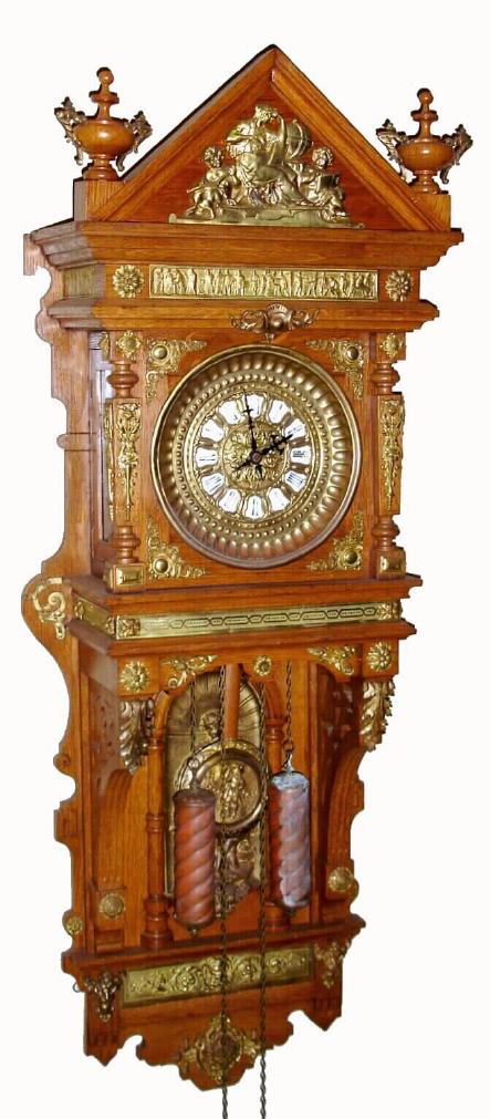 Ansonia Clock Co., "ANTIQUE - HANGING" in oak with brass trimmings, 2-weight chain drive, gong striking movement, and brass dial with individual porcelain cartouche numerals; hinged doors on sides for access to hang pendulum and set beat, c.1809 — Antique Clocks Price Guide