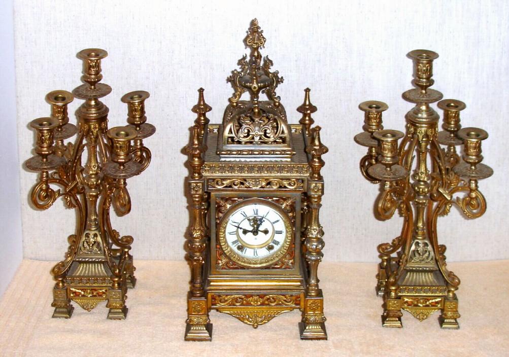 Ansonia Clock Co. New York, C.1906, "REGENT and CANDELABRAS", 3-piece set, 8-day time and strike with open escapement on the dial, the case and candle stands of white metal, brass plated {original}. — Antique Clocks Price Guide