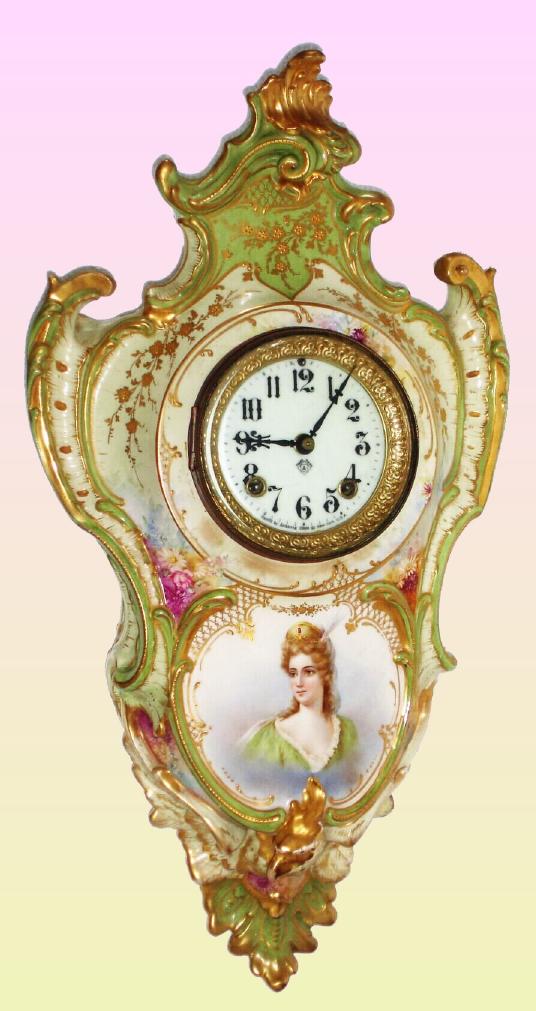 Ansonia Clock Co., C.1906, Royal Bonn, "PORCELAIN HANGING No. 3" china cased wall clock, with portrait on lower case, gong strike, pendulum, 8-day mov't. Case is cream colored with princess in hat with low cut green dress. — Antique Clocks Price Guide
