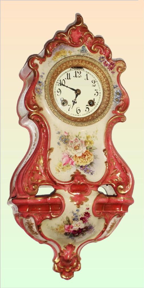 Ansonia Clock Co., C.1906, Royal Bonn, "PORCELAIN HANGING No. 2" china cased wall clock, with flower pattern to case, bell strike balance wheel, 8-day mov't. The white/cream case has rich pink accent with gold highlights. — Antique Clocks Price Guide