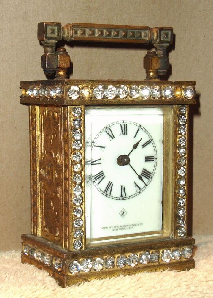 Ansonia Clock Co., New York, C.1906, "BONANZA" cast metal carriage clock, profusely decorated with brilliants on case front and sides, 1-day timepiece. — Antique Clocks Price Guide