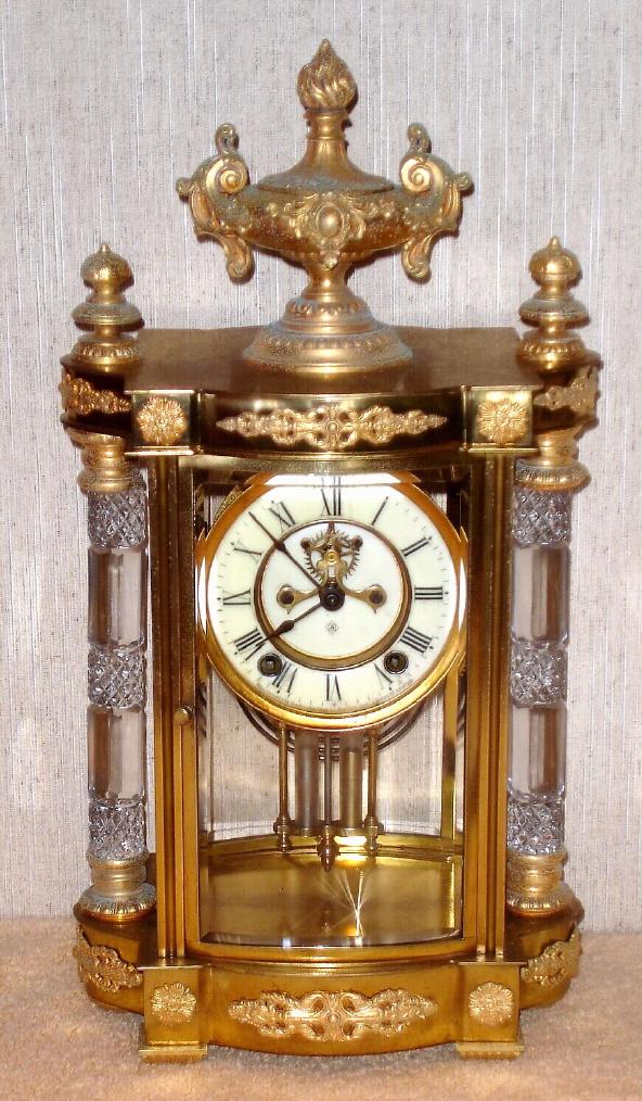 Ansonia Clock Co., New York, C.1904, "JUPITER", 4-glass, crystal regulator with 2-vial pendulum, open escapement on porcelain dial. — Antique Clocks Price Guide