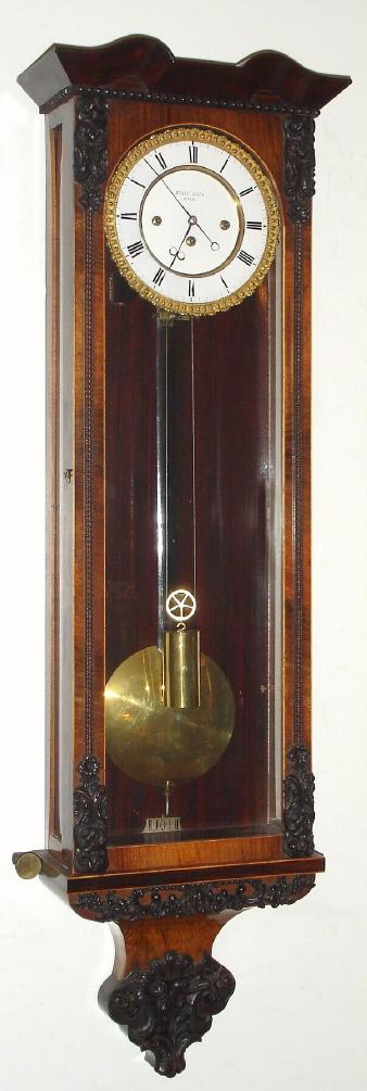 Austrian, Adolf Koll, Wien, Biedermeier era "Vienna Regulator", full quarter striking grand sonnerie, weight driven, with springs for the striking trains, 2-day. The case with rosewood veneer on outer surfaces, front of back is grained, slide mount movement on seatboard. — Antique Clocks Price Guide