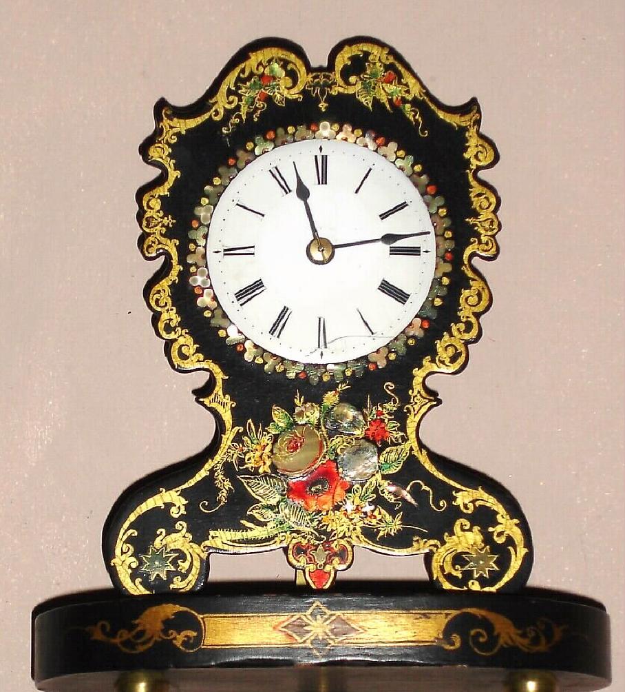 Chauncey Jerome, New Haven, Conn, C.1850, paper mache model shelf clock with 1-day Botsford movement, and old glass dome. Colorful and vibrant front or shield was made by the Litchfield Mfg. Co. — Antique Clocks Price Guide