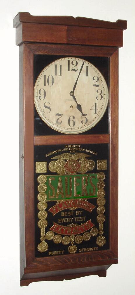 New Haven Clock Co., Advertising timepiece for "SAUER'S Flavoring Extracts, Best By Every Test, Purity and Strength", wall hanging, 8-day, spring. — Antique Clocks Price Guide