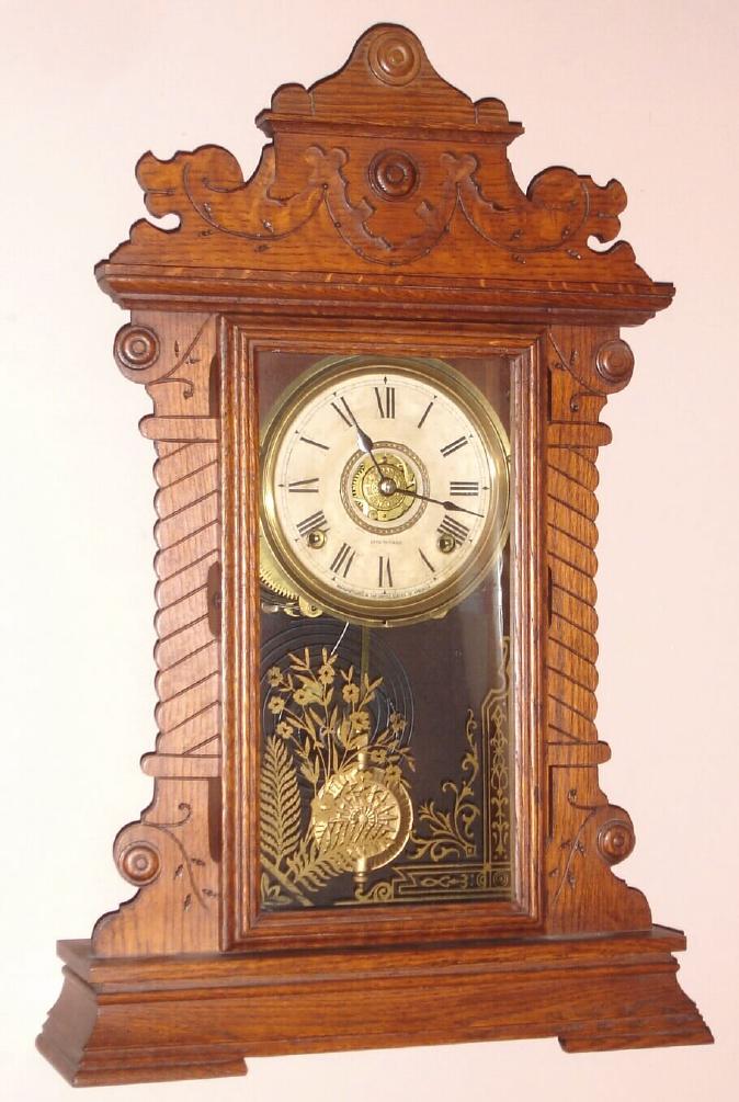 Seth Thomas Clock Company, Thomaston Conn gingerbread clock 8 day time, half hour strike and alarm spring driven mvt in oak case with Roman numeral signed dial, c1895 — Antique Clocks Price Guide