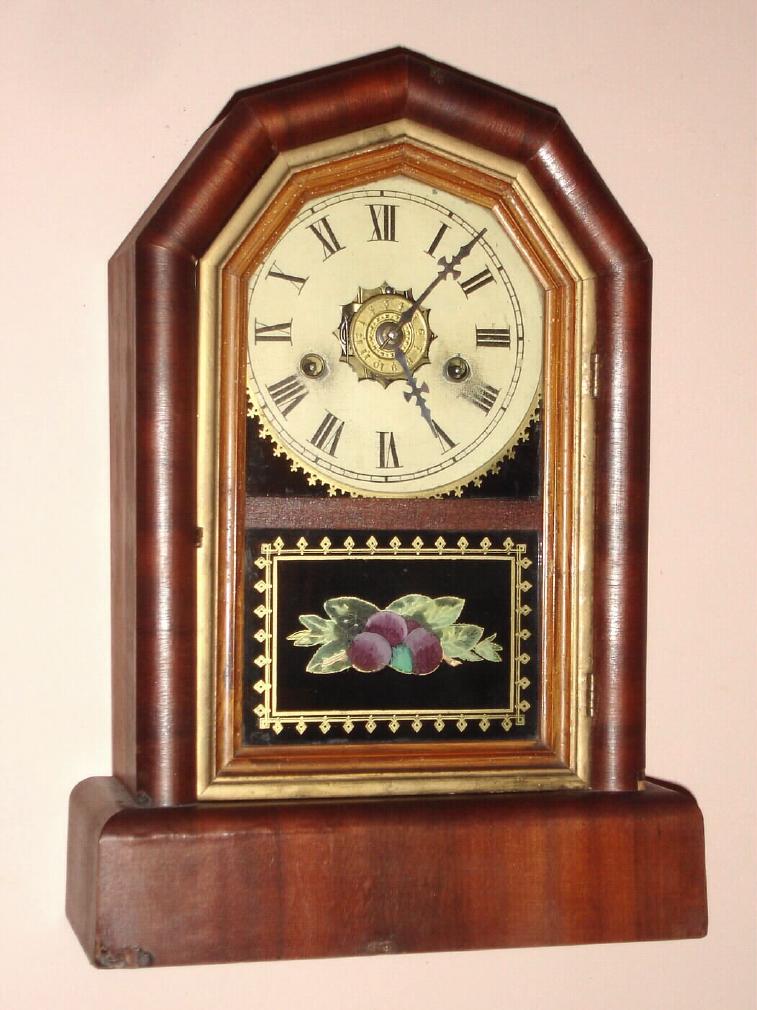 New Haven Clock Co., New Haven Conn. "OCTAGON PRIZE" mantel clock 30 hour, time and strike and alarm spring driven mvt in mahogany veneered case with Roman numeral painted zinc dial, c1878 — Antique Clocks Price Guide