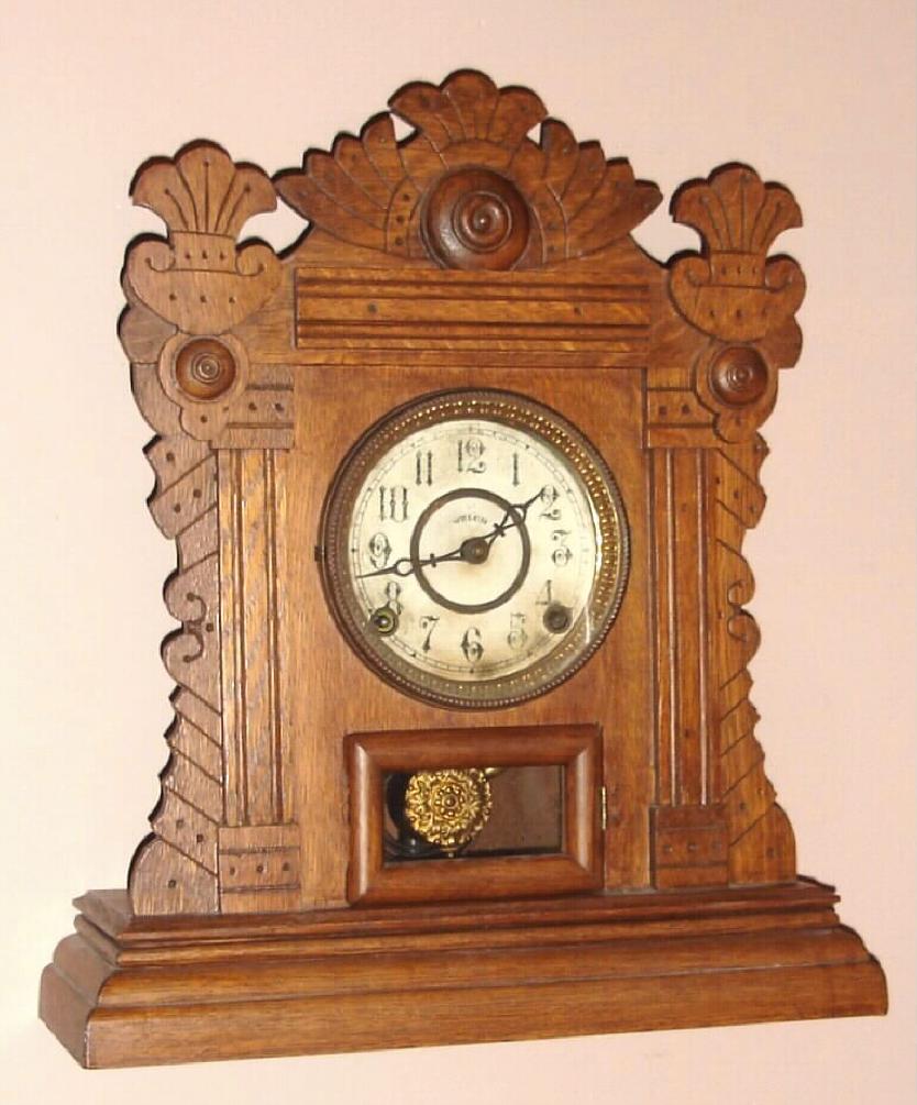 E.N. Welch Mfg. Co., Forestville Conn. "MARTINI" model mantel clock with 8 day time and half hour strike spring driven mvt in oak case with Arabic numeral painted gilt pan dial, c1891 — Antique Clocks Price Guide
