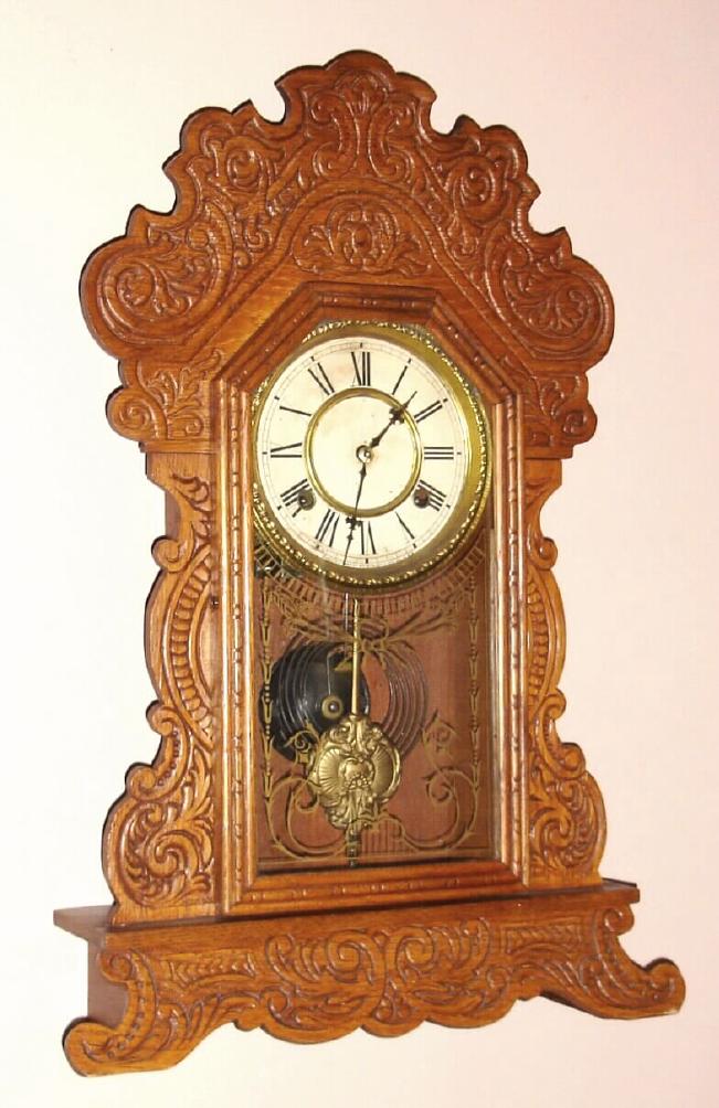 Waterbury Clock Co., Waterbury Conn. "FESTUS" model 8 day, time and strike spring driven mvt in oak case with Rococo gilt pan 6" dial, c1906 — Antique Clocks Price Guide