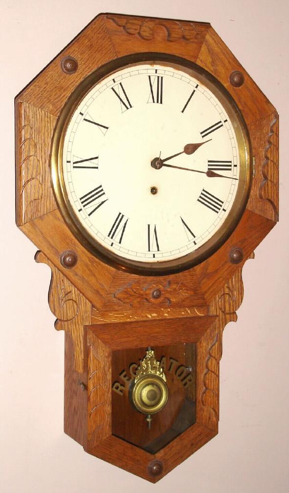 New Haven Clock Co., New Haven, Conn. "BLAKE" model 8 day time only spring driven mvt in oak short drop octagon case with applied carved trim pieces and RN paper over gilt pan 12" dial, c1900 — Antique Clocks Price Guide