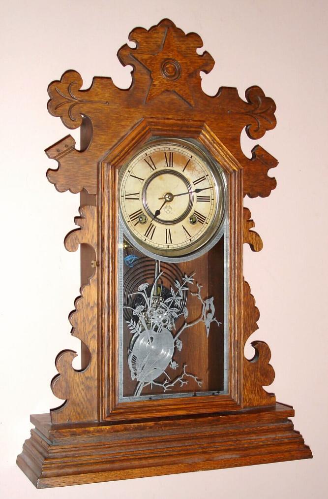 Ansonia Clock Co., Ansonia, Conn. "BERKELEY" model 8 day time and strike spring driven mvt in carved walnut case with Roman 6" nickel plated pan dial, c1894 — Antique Clocks Price Guide