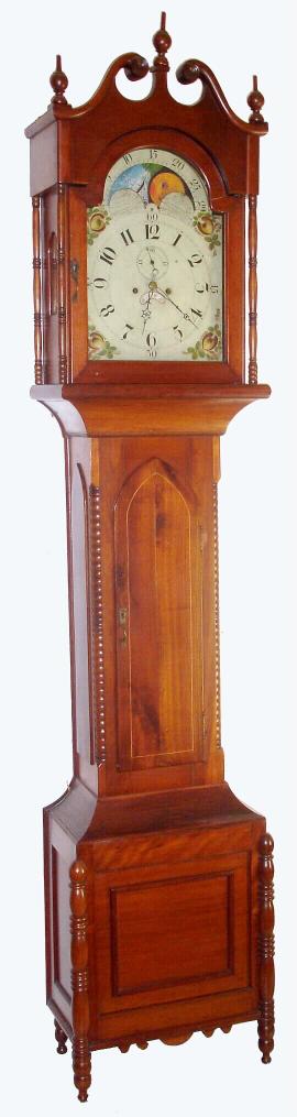 Unsigned Pennsylvania Tall clock, probably Montgomery County, 8-day, painted rolling moon dial, in a cherry case with full turned columns flanking the dial, and turned spindle style quarter columns flanking the center of the case, and with 4 spindle feet. 2-wt. c.1825. — Antique Clocks Price Guide