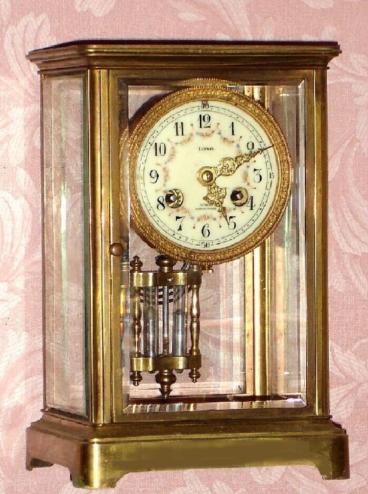 French, Vincenti and Cie, 8-day time and gong strike, 4-glass crystal regular, in a smaller than usual size, and with porcelain dial having polychrome floral decorations, and the inscription "Long" and Boston, c.1900. — Antique Clocks Price Guide