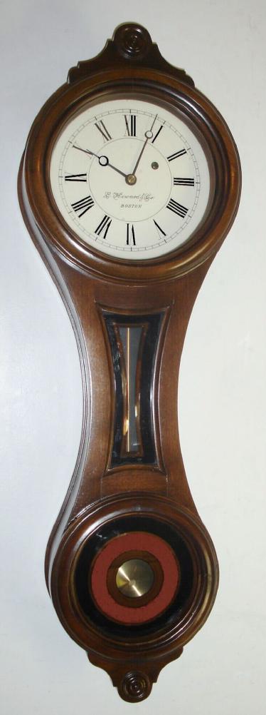 E. Howard and Co, Boston, "REGULATOR No. 10", figure 8 wall clock, in a walnut case with reverse painted tablets, invar pendulum rod, eight day, serial No. 331, C.1976, along with its framed certificate of origin, dated Nov 1, 1976 and signed by D. J. Blackwell. Consigned by the original purchaser, H. Newman. — Antique Clocks Price Guide