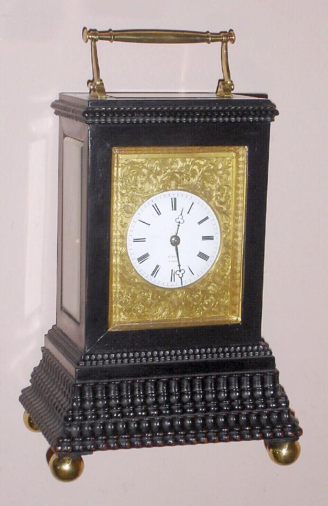 French, Henry Marc, brass cased carriage clock half hour strike signed on dial and spring driven mvt with helical hairspring and counterpoised platform escapement in ebonized ripple molded case with Roman porcelain dial surrounded by engraved gilt mask, c1885 — Antique Clocks Price Guide