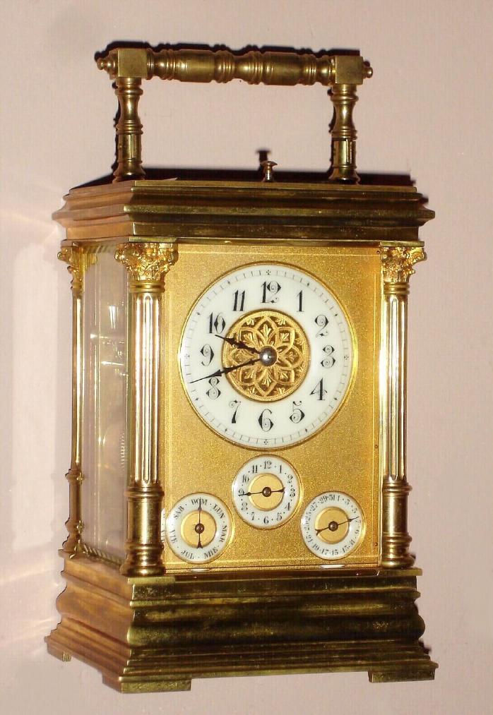 Carriage clock French with Petite and Grande Sonnerie, quarter hour repeat, alarm and day / date calendar 8 day spring driven movement with platform lever escapement in Anglais Riche case with Corinthian columns surmounted by fancy capitals with Arabic numeral porcelain chapter rings on time dial, alarm dial and both calendar dials, c1900 — Antique Clocks Price Guide