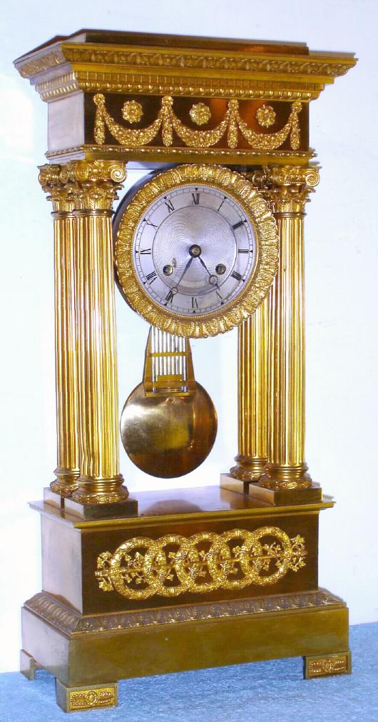 French , Circa 1900, 8-day time and bell strike 4-pillar empire style mantel clock in ormolu and cast appliques. compensating pendulum and vernier beat set [thumb screw]. — Antique Clocks Price Guide