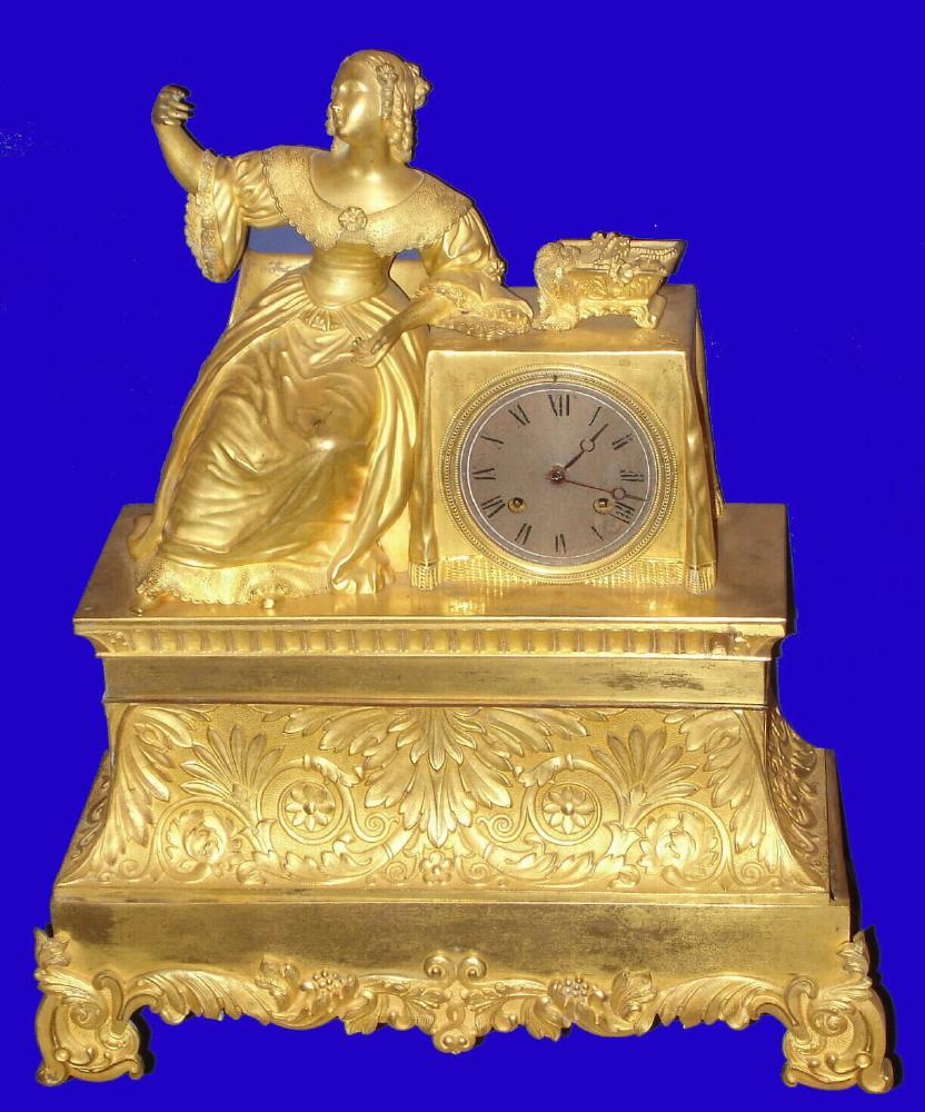 French, ormolu figural clock, A Lady at her Dressing Table, with an open box of jewels, 8-day time and bell strike, with silk thread movement, C.1840. This clock is larger than average. — Antique Clocks Price Guide