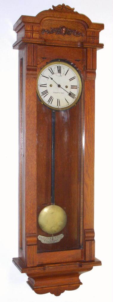 New Haven Clock Co., C.1890, "COLUMBIA" model wall timepiece, 30 day duration, in a golden oak case, with restoration. — Antique Clocks Price Guide