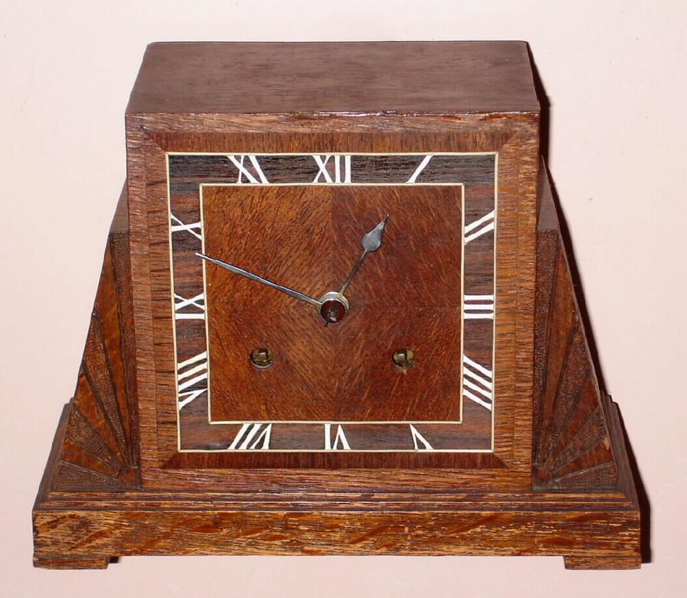 English, c.1925, Astral, going barrel movement, in an oak veneer Art Deco case with MOP inlay for the Roman numerals. Gong strike, 8-day. — Antique Clocks Price Guide