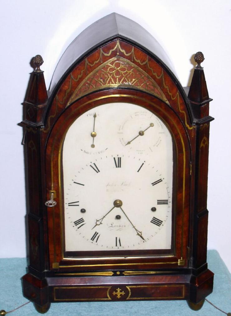 English, John Fleet, 6-tune musical bracket clock, in a Gothic styled mahogany case with brass inlay, and a painted dial with subsidiary rings in the arch for Chime-Not Chime, and the right ring with the tunes: God Save the King, Del Caros Fancy, Russian Dance, Bonny Lad, White Cockade and Miss Barker's Hornpipe, playing on a nest of 12 bells with 13 hammers, the 3-train mov't with chain fusees and engraved back plate, C.1820 — Antique Clocks Price Guide