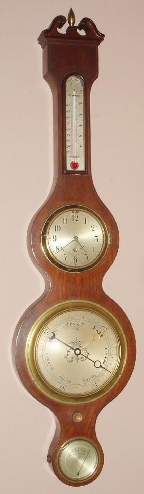 Chelsea Clock Co., CARVER model barometer and timepiece, first offered in 1937, and this one serial No. 410385, c.1944. In addition, there is a thermometer in the throat and a hygrometer in the lower section of the mahogany "banjo" style case. — Antique Clocks Price Guide