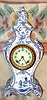 Ansonia Clock Co., C.1895, Royal Bonn, "LA ROCHELLE", decorated in Blue Delft style, and signed on rear "Royal Bonn/Delft", with smaller 8-day Ansonia movement and with fancy cream dial with numerals on blue background.