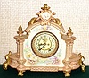 Ansonia Clock Co., C.1895, Royal Bonn, "LA CHAMPAGNE" porcelain china cased clock, with 8-day, gong strike mov't with open escapement on porcelain dial. Color is beige with gold highlights and multi color floral decorations.