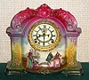 Ansonia Clock Co., C.1910, Royal Bonn, "LA ORB" porcelain china cased clock, with 8-day, gong strike mov't with open escapement on porcelain dial, in a multi-colored case, red top, yellow center + dark green at base, with multi colored floral decorations. Best part is the hand painted scene at bottom showing Dutch ladies saying farewell to their sailing husbands {ships in background}.