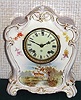 Ansonia Clock Co., C.1895, Royal Bonn, "LA MURE" porcelain china cased clock, with 8-day, gong strike mov't with hand painted scene of 2 deer at a pond in the wilderness, solid porcelain dial, with red trim between numerals.