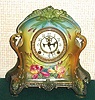 Ansonia Clock Co., C.1905, Royal Bonn, "LA PLATA" porcelain china cased clock, with 8-day, gong strike mov't with open escapement on porcelain dial, in a multi-colored case, aqua/green top, yellow center + dark green at base, with purple and yellow iris decorations and gold highlights.