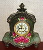 Ansonia Clock Co., C.1914, Royal Bonn, "LA FLANDRE" porcelain china cased clock, with 8-day, gong strike mov't with open escapement on porcelain dial, in a very dark muted green case with red roses.
