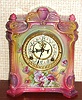 Ansonia Clock Co., C.1915, Royal Bonn, "LA SEINE" porcelain china cased clock, with 8-day, gong strike mov't with open escapement on porcelain dial, in a multi-colored pastel case in shades of pink, violet and blue, and with varied floral decorations to the front and sides.
