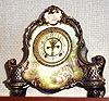 Ansonia Clock Co., C.1905, Royal Bonn, "LA VERA" porcelain china cased clock, with 8-day, gong strike mov't with open escapement on porcelain dial, in a cobalt blue case with 24K side decorations and portrait scene of lovers below the dial.