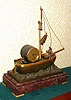 French, OARSMAN automaton timepiece, C.1885, a bronze sailboat setting on a nest of waves [also bronze], with the lone boatman rowing the boat due to lack of wind. The oarsman is suspended on a tri-leaf "swinger" type suspension, and the assembly is a compound pendulum, with a threaded bob at the bottom for adjustment.