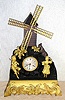 French, Automaton Figural clock, the dial marked LeRoy, Paris, with a windmill powered by a separate movement in the base, and a bag-piper piping while a costumed girl to the right is dancing, and behind a silvered goat is eating flowers, C.1880