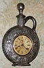 Ansonia Clock Co., New York, C.1900, "JUG" cast metal desk novelty in the shape of a pitcher or jug, with one day timepiece movement.