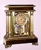 French, Japy Freres, C.1900, 4-Glass CRYSTAL REGULATOR, in a fancy brass Empire style case with 4 full columns, retailed by Bigelow, Kennard and Co., Boston {signed on gilt / engine turned brass dial} moon hands.
