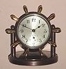 Chelsea Clock Co., Boston, C.1949, CLINTON model desk clock with 2 3/4 inch dial, and tu-tone case with bronze base and tub with yellow brass handles. This model was first introduced in 1931. 8-day, time. A presentation piece, engraved on the base to "Herbert D. Hancock, 1924-1949, from his friends at the CHELSEA EVENING RECORD" [newspaper]