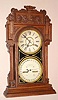 Waterbury Clock Co., Waterbury, Conn. "CALENDAR NO. 43" double dial perpetual calendar with 8 day time and strike spring driven mvt in walnut case with two 8" gilt pan dials, c1912
