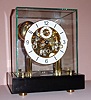 Franz Hermle Germany skeletonized mantle clock with 8 day time and strike 11J gilt spring driven mvt striking the hours and chiming the quarter hours on nest of four bells with Arabic numeral chapter ring, c1990