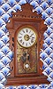 E. N. Welch Mfg. Co, "ERMINE", walnut gingerbread clock, time, gong strike and bell alarm, 8-day. C.1884.