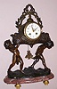 French, Japy Freres, figural clock in white metal case, the 8 day time and strike spring driven clock resting in a floral basket supported by nimble cherubs with a floral basket pendulum on rose and grey mottled marble base with cast brass feet and Arabic numeral polychrome accented 3 1/2" dial, c1890