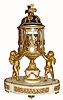 French, Ormolu and White Marble Temple motif clock with revolving annular dials, C.1875. The bell striking movement with platform lever escapement, driving two porcelain cartouche time rings, top minutes and bottom - hours, and in excellent original condition. The movement sets in a glass surrounded temple with ormolu plume filial, on a leaf cast pediment, and supported from either side by a gilt winged putti, all on an oval white base with inset floral ormolu friezes and gilded feet.