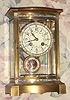 French, Bow front brass and glass, with enamel Portrait pendulum and brilliant dial and pend surround, c.1900, 8-day, gong strike. Case has full bands of multi color enamel decorations top and bottom.