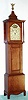 Reproduction dwarf tall case, in the style of Joshua Wilder, Hingham, Mass and with his name and town applied to the dial, C.1980, cherry case with turned columns flanking the dial.