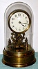 Eureka Clock Co Ltd, London battery powered, electro-magnetic timepiece mounted on brass base under dome with exposed rotating balance, serial No. 7183 c1910